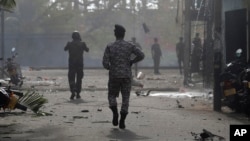 Sri Lankan security forces approach the site after a vehicle parked near St. Anthony's shrine exploded in Colombo, Sri Lanka, April 22, 2019.