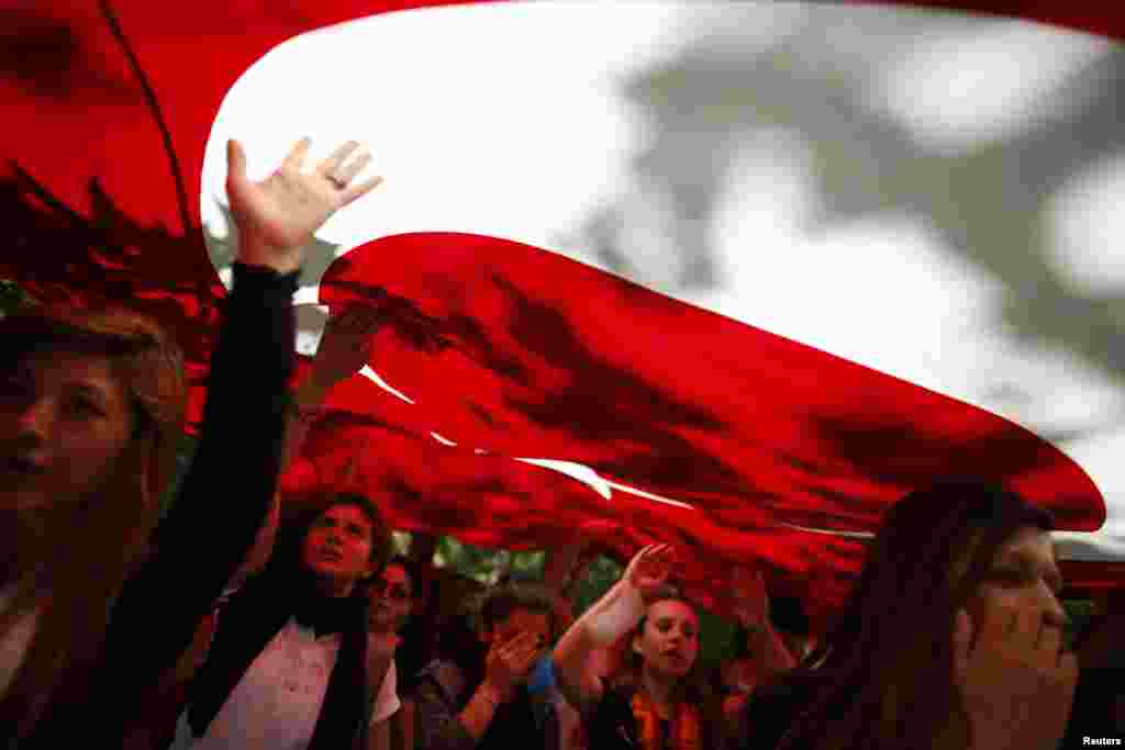 Para demonstran membawa bendera&nbsp;Turki dan meneriakkan slogan-slogan anti-pemerintah dalam demonstrasi di Taman Gezi dekat Alun-Alun Taksim, Istanbul (3/6). 
