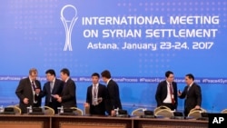 Kazakhstan officials prepare working space for delegations at a hotel in Astana, Kazakhstan, Jan. 23, 2017.