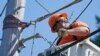 A worker installs fiber optic cable to bring broadband internet service to a rural area near Belfair, Wash., Aug. 4, 2021. High-speed internet is a key area of President Biden's $1 trillion infrastructure package passed by the Senate Aug. 10, 2021.
