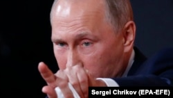 Putin gestures during his annual press conference in Moscow, December 14, 2017.