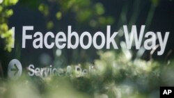 In this April 25, 2019 file photo, an address sign for Facebook Way is shown in Menlo Park, Calif. (AP Photo/Jeff Chiu, File)