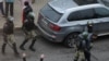 A demonstrator is taken away by Belarusian law enforcement officers during a rally to reject the presidential election results in Minsk, Belarus, Nov. 15, 2020. 