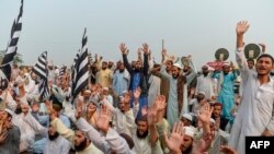 Supporters of Islamic political party Jamiat Ulema-e-Islam (JUI-F) shout slogans as they block a highway during an anti-government protest in Karachi, November 14, 2019.