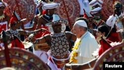 Pope Francis is greeted upon his arrival at the Colombo's Bandaranaike international airport, Jan. 13, 2015.