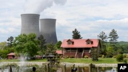 FILE - The Watts Bar Nuclear Plant cooling towers Unit 1, left, and Unit 2 rise near Spring City, Tenn., April 29, 2015.