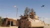 Egyptian Army soldiers in armored personnel carriers and a helicopter gunship patrol through a village in the northern Sinai, Sept. 7, 2013.