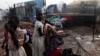 South Sudanese girls displaced by the fighting collect their laundry from a barbed wire in a camp for displaced persons in the UNMISS compound in Tongping in Juba February 19, 2014. Thousands of people have been killed and more than 800,000 have fled thei