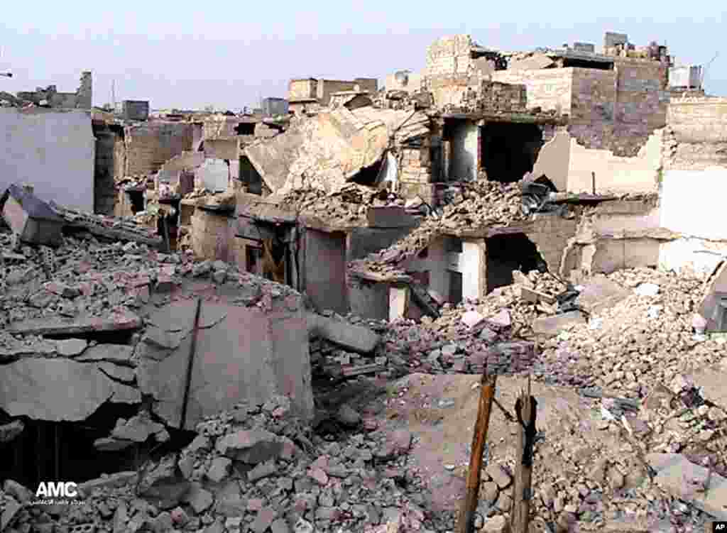Homes are seen destroyed by Syrian government airstrikes and shelling in the neighborhood of Karam Tarab near Aleppo International Airport, July 2, 2013. (Citizen journalism image)