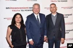 Co-directors Bonni Cohen, left, and Jon Shenk, right, pose with former U.S. Vice President Al Gore at a special screening of "An Inconvenient Sequel: Truth To Power" at The Whitby Hotel in New York, July 17, 2017.