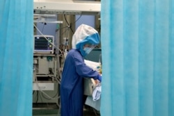 A nurse tends to a patient inside a COVID-19 intensive care unit of the Tor Vergata Polyclinic Hospital in Rome, Italy, Dec. 13, 2020.