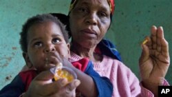 HIV positive child is given some jam prior to her ARV, near Durban, South Africa, 30 Nov 2010