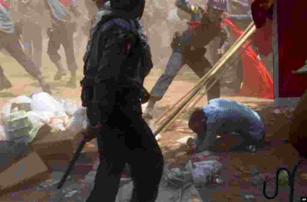 A police officer beats a student protester in Letpadan, Myanmar,&nbsp; March 10, 2015.