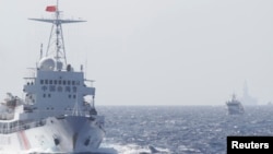 FILE - Ships of Chinese Coast Guard are seen near Chinese oil rig Haiyang Shi You 981 in the South China Sea, about 210 km (130 miles) off shore of Vietnam.