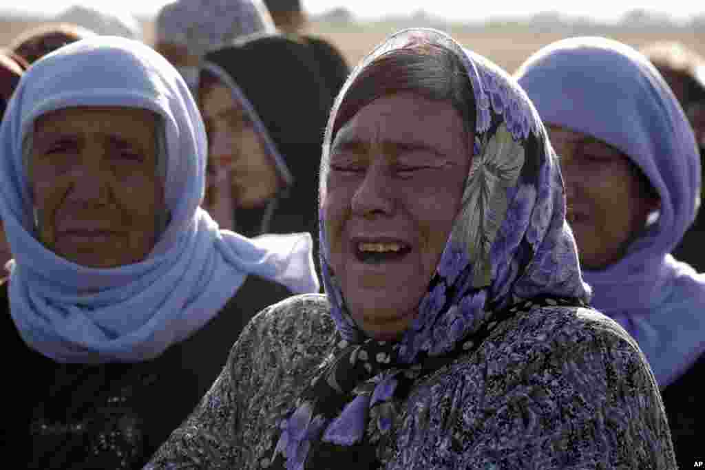 A Kurdish woman weeps as she mourns during the funeral of three Kurdish fighters, killed while fighting Islamic State militants, Suruc, Turkey, Oct. 23, 2014.