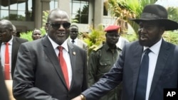 FILE - South Sudan's First Vice President Riek Machar (L) and President Salva Kiir (R) shake hands following the first meeting of a new transitional coalition government, in the capital Juba, South Sudan, April 29, 2016. 