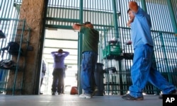 FILE - Suspected illegal immigrants are being processed at the Tucson Sector of the U.S. Customs and Border Protection headquarters in Tucson, Ariz., Aug. 9, 2012.
