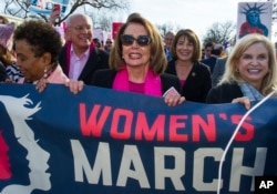 House Minority Leader Nancy Pelosi, D-Calif., center, Rep. Susan Davis, D-Calif, background center right, and Rep. Carolyn Maloney, D-N.Y., right, participate in the Women's March walk to the White House in Washington, Jan. 20, 2018. On the anniversary of President Donald Trump’s inauguration, people participating in rallies and marches in the U.S. and around the world Saturday denounced his views on immigration, abortion, LGBT rights, women's rights and more.