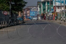 A barbwire blocks a deserted street on the first anniversary of India’s decision to revoke the disputed region’s semi-autonomy, in Srinagar, Indian-controlled Kashmir, Aug. 5, 2020.