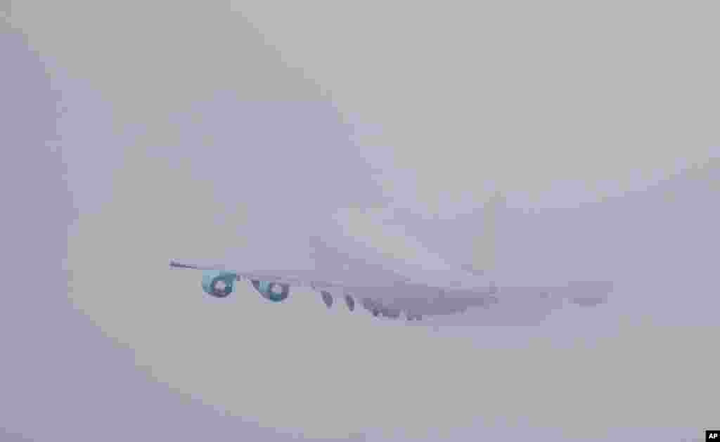 Air Force One, with President Barack Obama aboard, disappears in thick fog over Andrews Air Force Base, Maryland, as it takes off for a trip to Raleigh, North Carolina.