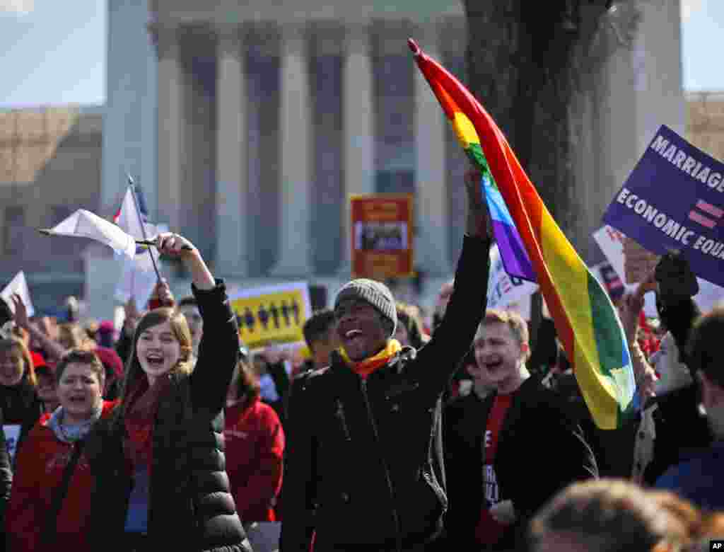Demonstrators chant outside the Supreme Court in Washington as the court heard arguments on California's Proposition 8, March 26, 2013.
