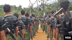 Arakan Army recruits scale the climbing ropes at the Laiza, Kachin State base camp.