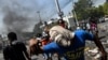 Haiti Protesters March to Affluent Suburb to Await President's Resignation