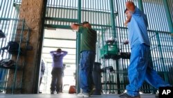 FILE - Suspected illegal immigrants are being processed at the Tucson Sector of the U.S. Customs and Border Protection headquarters in Tucson, Arizona, Aug. 9, 2012.