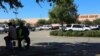 In north Houston, a group of mostly undocumented, Latino men wait outside a Home Depot, in search of manual cleanup work.