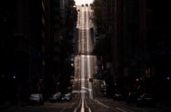 FILE - California Street, usually filled with cable cars, is seen empty in San Francisco, California, on March 18, 2020.