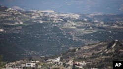 FILE - A view towards the Turkish border from Kinsibba, Syria.