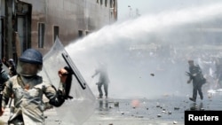 Afghans throw stones toward security forces during a protest in the wake of Wednesday's deadly bombing, in Kabul, Afghanistan, June, 2, 2017. 