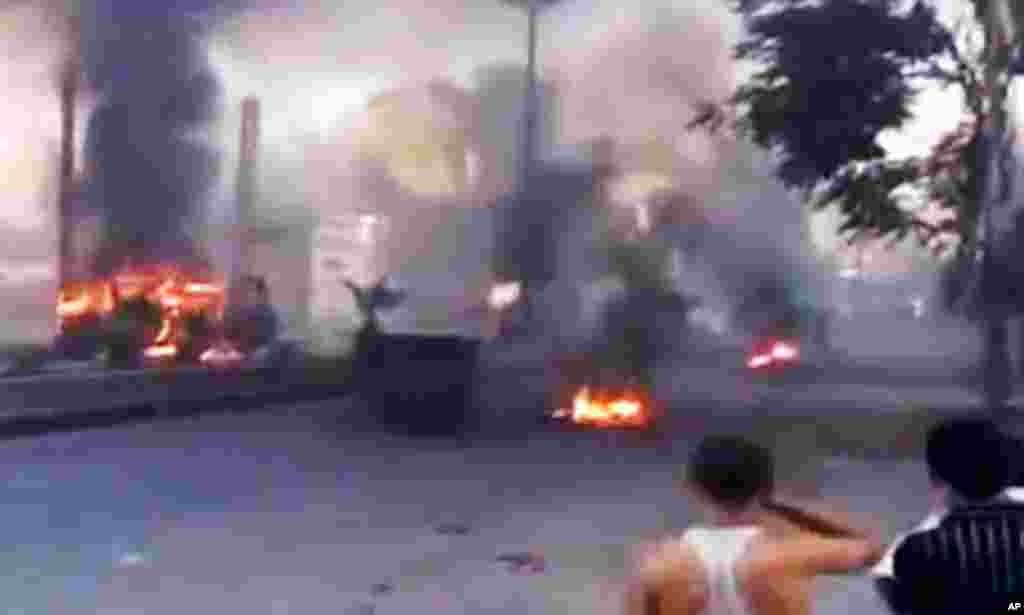 This image made from amateur video released by the Ugarit News and accessed July 18, 2012, purports to show burning tires in Damascus, Syria.