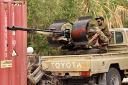 FILE - Fighters loyal to the UN-recognized Libyan Government of National Accord (GNA) are pictured during clashes with forces loyal to strongman Khalifa Haftar in an area south of the Libyan capital Tripoli on June 1, 2020.