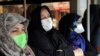 Commuters wear masks on a public bus in downtown Tehran, Iran, Feb. 23, 2020. Iran's Health Ministry raised the death toll from the new coronavirus to eight people in the country.