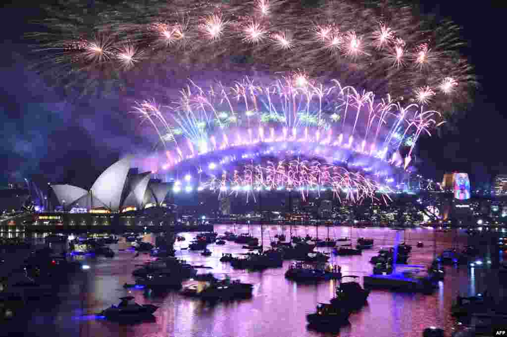 New Year&#39;s Eve fireworks burst over Sydney&#39;s famous Harbour Bridge and Opera House in Australia, during the fireworks show, Jan. 1, 2019.