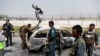 Afghan police officers inspect a vehicle from which insurgents fired rockets, in Kabul, Afghanistan, Aug. 18, 2020.