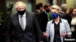 FILE - European Commission President Ursula von der Leyen welcomes British Prime Minister Boris Johnson in Brussels, Belgium, Dec. 9, 2020.