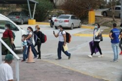 The first group of 27 migrants leave their camp towards the Gateway International Bridge to be processed and seek asylum in the U.S., in Matamoros, Mexico, Feb. 25, 2021.