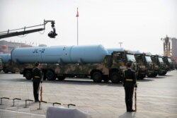 FILE - Military vehicles carrying JL-2 submarine-launched missiles roll during a parade to commemorate the 70th anniversary of the founding of the People's Republic of China in Beijing, Oct. 1, 2019.
