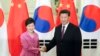 Chinese President Xi Jinping (R) shakes hands with South Korean President Park Geun-hye at the Great Hall of the People in Beijing, Sept. 2, 2015.