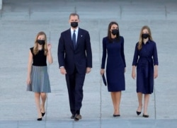 FILE - Spain's King Felipe, Queen Letizia, Princess Leonor and Infanta Sofia arrive to a state tribute in memory of Spain's COVID-19 victims at Royal Palace in Madrid, Spain, July 16, 2020.