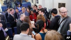 Reporters line up in hopes of attending a briefing in Press Secretary Sean Spicer's office at the White House in Washington, Feb. 24, 2017.