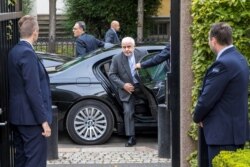 Iran's Foreign Minister Javad Zarif is surrounded by bodyguards as he arrives for a meeting in Oslo, Norway, Aug. 22, 2019.