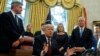 President Donald Trump answers a reporters question about the investigation of special counsel Robert Mueller during a signing ceremony of the "Cybersecurity and Infrastructure Security Agency Act," in the Oval Office of the White House, Nov. 16, 2018, in Washington.