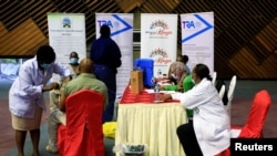 FILE - Kenyan tour guides and travel operators prepare to receive shots of the AstraZeneca coronavirus vaccine, under the COVAX program, in Nairobi, Kenya, April 27, 2021.