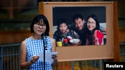 Hua Qu speaks to people attending a vigil for Xiyue Wang at Princeton University in Princeton, N.J. Sept. 15, 2017.