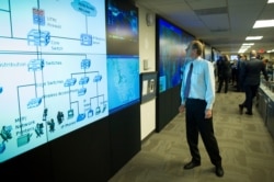 One of the large video screens is checked in the Department of Homeland Security's National Cybersecurity and Communications Integration Center in Arlington, Virginia, Aug. 22, 2018.
