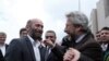 FILE - Journalists Can Dundar, right, and Erdem Gul, Ankara bureau chief of Cumhuriyet newspaper, speak before the start of their trial, hours before the attack on Can Dundar outside city's main courthouse in Istanbul, May 6, 2016. 