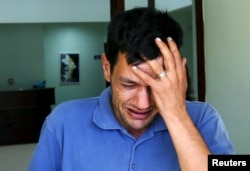 Abdullah Kurdi, father of three-year old Aylan Kurdi, cries as he leaves a morgue in Mugla, Turkey, Sept. 3, 2015.